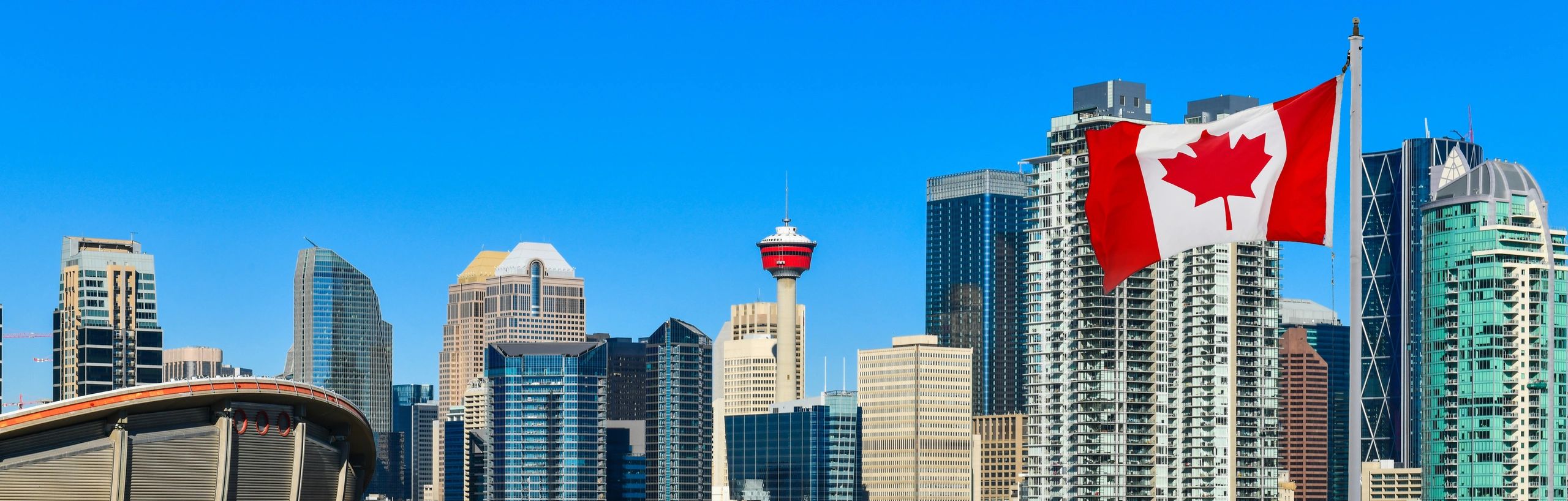 Canadian flag over Calgary skyline representing local legal services
