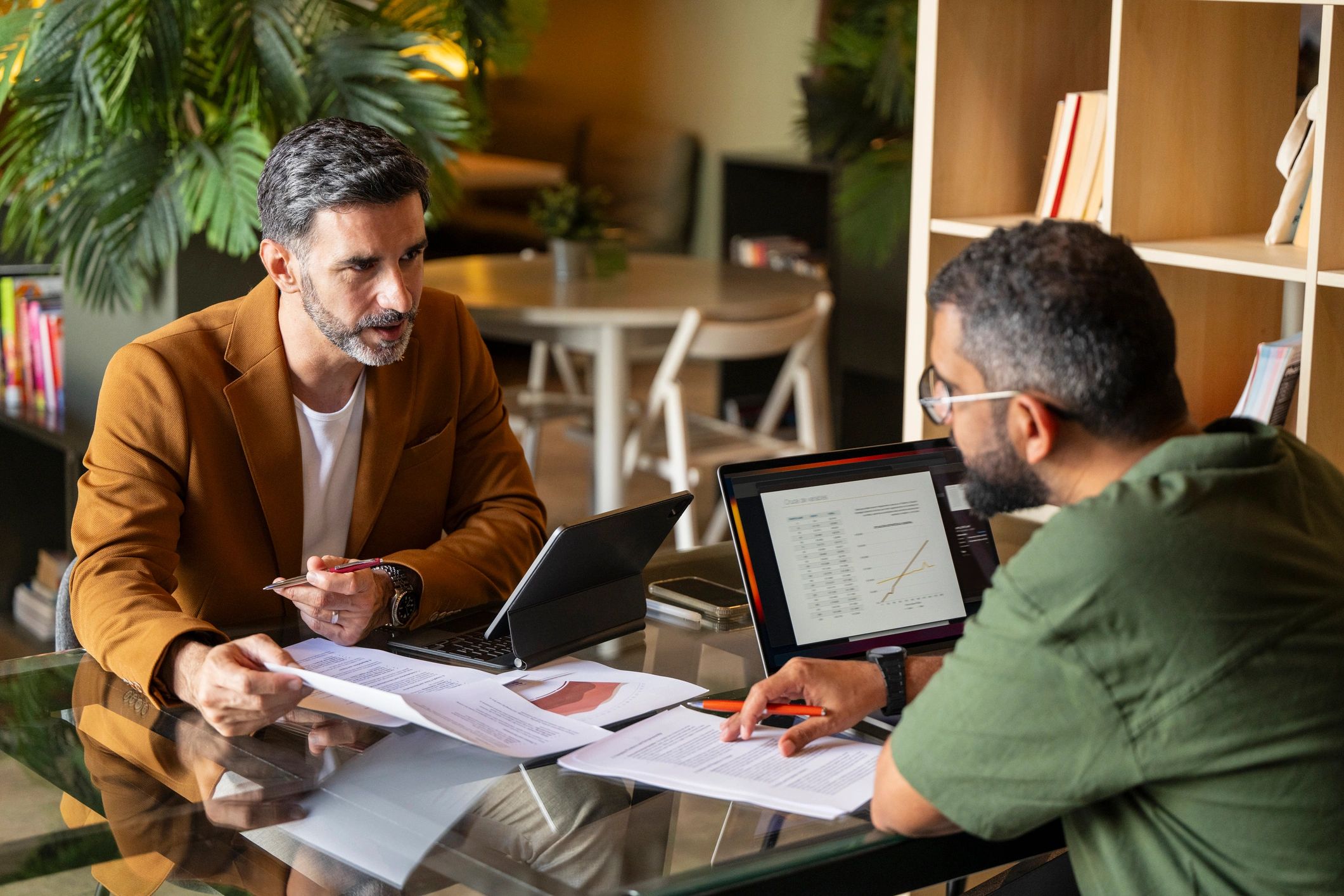 Lawyer consultation with client documents on a desk